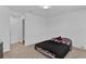 Simple bedroom with full-size bed and door to bathroom at 1174 Seaside Mist Trl, Kissimmee, FL 34747