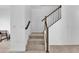 Modern staircase with dark wood railing and neutral carpet at 1174 Seaside Mist Trl, Kissimmee, FL 34747