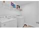 Bright laundry room with washer, dryer, and shelving at 1174 Seaside Mist Trl, Kissimmee, FL 34747