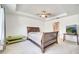 Main bedroom with plush carpeting, ceiling fan, and large window at 121 Big Black Dr, Kissimmee, FL 34759