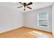 Bright bedroom featuring wood floors and a window with blinds at 3330 La Salle Ave, Saint Cloud, FL 34772