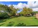 Expansive green lawn area with mature trees in the community at 404 Banyon Tree Cir # 200, Maitland, FL 32751