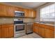 Kitchen boasts wood cabinets, stainless steel appliances, and granite countertops at 404 Banyon Tree Cir # 200, Maitland, FL 32751