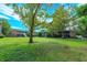 Spacious grassy area with mature trees and brick buildings at 404 Banyon Tree Cir # 200, Maitland, FL 32751