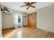 Light-filled bedroom with hardwood floors and double doors at 4150 Citrus St, Kissimmee, FL 34746
