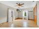 Bright bedroom featuring hardwood floors, ceiling fan, and window coverings at 4150 Citrus St, Kissimmee, FL 34746