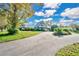 A-frame home with stone and metal siding sits on a spacious lot with a long driveway at 4150 Citrus St, Kissimmee, FL 34746