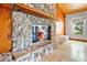 Rustic stone fireplace with wood mantle and glass doors at 4150 Citrus St, Kissimmee, FL 34746