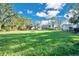 Large grassy lot with a new house in the background at 4150 Citrus St, Kissimmee, FL 34746