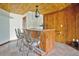Basement bar with rustic wood finishes and wrought iron barstools at 4150 Citrus St, Kissimmee, FL 34746