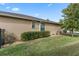 Landscaped backyard with green grass and a tan house at 5307 Cortland Dr, Davenport, FL 33837