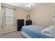 Bedroom with double door closet, window, and carpeted floor at 5307 Cortland Dr, Davenport, FL 33837