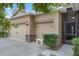 Tan house with three car garage, stone accents, and lush landscaping at 5307 Cortland Dr, Davenport, FL 33837