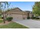 Two-story house with beige siding, three car garage, and neatly landscaped yard at 5307 Cortland Dr, Davenport, FL 33837