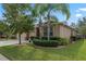 One-story house with beige siding, two car garage, and tropical landscaping at 5307 Cortland Dr, Davenport, FL 33837