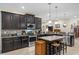 Spacious kitchen with dark cabinetry, granite counters, and stainless steel appliances at 5307 Cortland Dr, Davenport, FL 33837