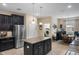 Spacious kitchen with dark cabinets, an island, and stainless steel appliances at 5307 Cortland Dr, Davenport, FL 33837