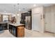 Modern kitchen with dark cabinetry, island, and stainless steel appliances at 5307 Cortland Dr, Davenport, FL 33837