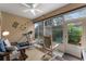 Sunroom with rocking chairs, treadmill and access to backyard at 5307 Cortland Dr, Davenport, FL 33837