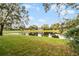 Landscaped backyard with pond view at 7621 Brightwater Pl, Oviedo, FL 32765