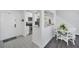 Bright dining area with white table and chairs, adjacent to kitchen at 770 Siena Palm Dr # 305, Celebration, FL 34747