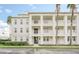 Three-story building with white siding, balconies, and palm trees at 770 Siena Palm Dr # 305, Celebration, FL 34747