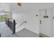 Hallway with stairs and a white door leading to the condo unit at 770 Siena Palm Dr # 305, Celebration, FL 34747