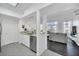Modern kitchen with stainless steel appliances and white cabinets, open to living area at 770 Siena Palm Dr # 305, Celebration, FL 34747