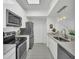 Modern kitchen with stainless steel appliances and white cabinets at 770 Siena Palm Dr # 305, Celebration, FL 34747