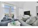 Spacious living room with gray sofas and large windows at 770 Siena Palm Dr # 305, Celebration, FL 34747