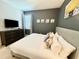 King-size bed in a well-lit bedroom with large TV at 7763 Westland Dr, Kissimmee, FL 34747