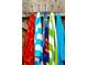 Five colorful beach towels hang on a rack at 7763 Westland Dr, Kissimmee, FL 34747