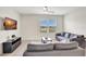 Living room with gray sofas and a large TV at 1117 Star Ruby Ln, Winter Haven, FL 33880