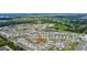 Aerial view of a residential community showcasing numerous homes and a lake at 1117 Star Ruby Ln, Winter Haven, FL 33880