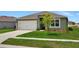 One story house with a green exterior, two car garage, and manicured lawn at 1117 Star Ruby Ln, Winter Haven, FL 33880