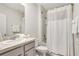 Clean bathroom with a shower/tub combo, vanity, and white shower curtain at 1117 Star Ruby Ln, Winter Haven, FL 33880
