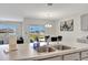 Kitchen features a large island with sink, modern appliances, and view to backyard at 1117 Star Ruby Ln, Winter Haven, FL 33880