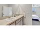 Double vanity bathroom with mirror and view of bedroom at 1117 Star Ruby Ln, Winter Haven, FL 33880
