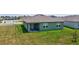 Single-story house with backyard patio, green lawn, and neighborhood view at 1117 Star Ruby Ln, Winter Haven, FL 33880