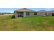 Large backyard with green grass and a view of neighboring houses at 1117 Star Ruby Ln, Winter Haven, FL 33880