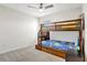 Bedroom with a bunk bed, ceiling fan, and window with blinds at 1117 Star Ruby Ln, Winter Haven, FL 33880