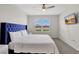 Elegant bedroom with plush bed and large window at 1117 Star Ruby Ln, Winter Haven, FL 33880