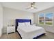 Bright bedroom with a blue velvet headboard and window coverings at 1117 Star Ruby Ln, Winter Haven, FL 33880