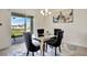 Dining room with glass table and black chairs, view to backyard at 1117 Star Ruby Ln, Winter Haven, FL 33880