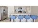 Island kitchen with stainless steel appliances and blue barstools at 1117 Star Ruby Ln, Winter Haven, FL 33880