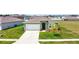 One story house with a green exterior, two car garage, and manicured lawn at 1117 Star Ruby Ln, Winter Haven, FL 33880