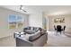 Living room with gray sofas and view into dining area at 1117 Star Ruby Ln, Winter Haven, FL 33880
