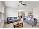 Open living room with gray sofas and kitchen view at 1117 Star Ruby Ln, Winter Haven, FL 33880