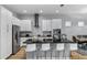 Modern kitchen featuring white cabinets, a large island, and stainless steel appliances at 1474 Fairview Cir, Kissimmee, FL 34747