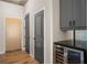 Modern condo entryway with wood flooring, gray doors, and a wine cooler at 155 S Court Ave # 1912, Orlando, FL 32801